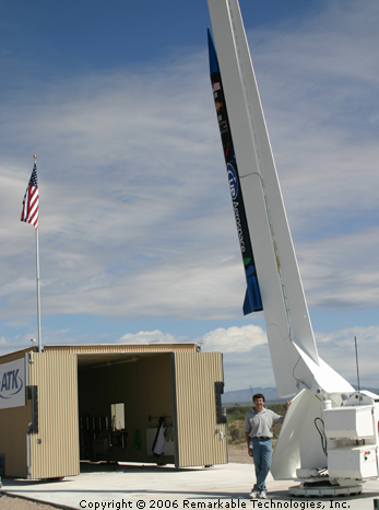 Eric Knight standing beneath the UP Aeropace "Spaceloft XL" rocket at the Spaceport America launch pad in New Mexico